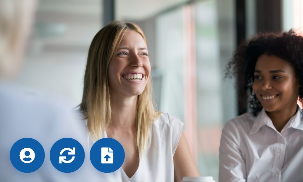 A woman laughing with her colleagues.