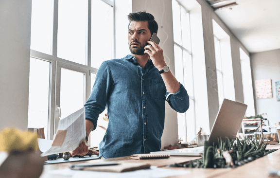 A man making a phone call in his office.